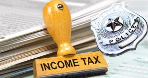 income tax stamp with law enforcement officer badge